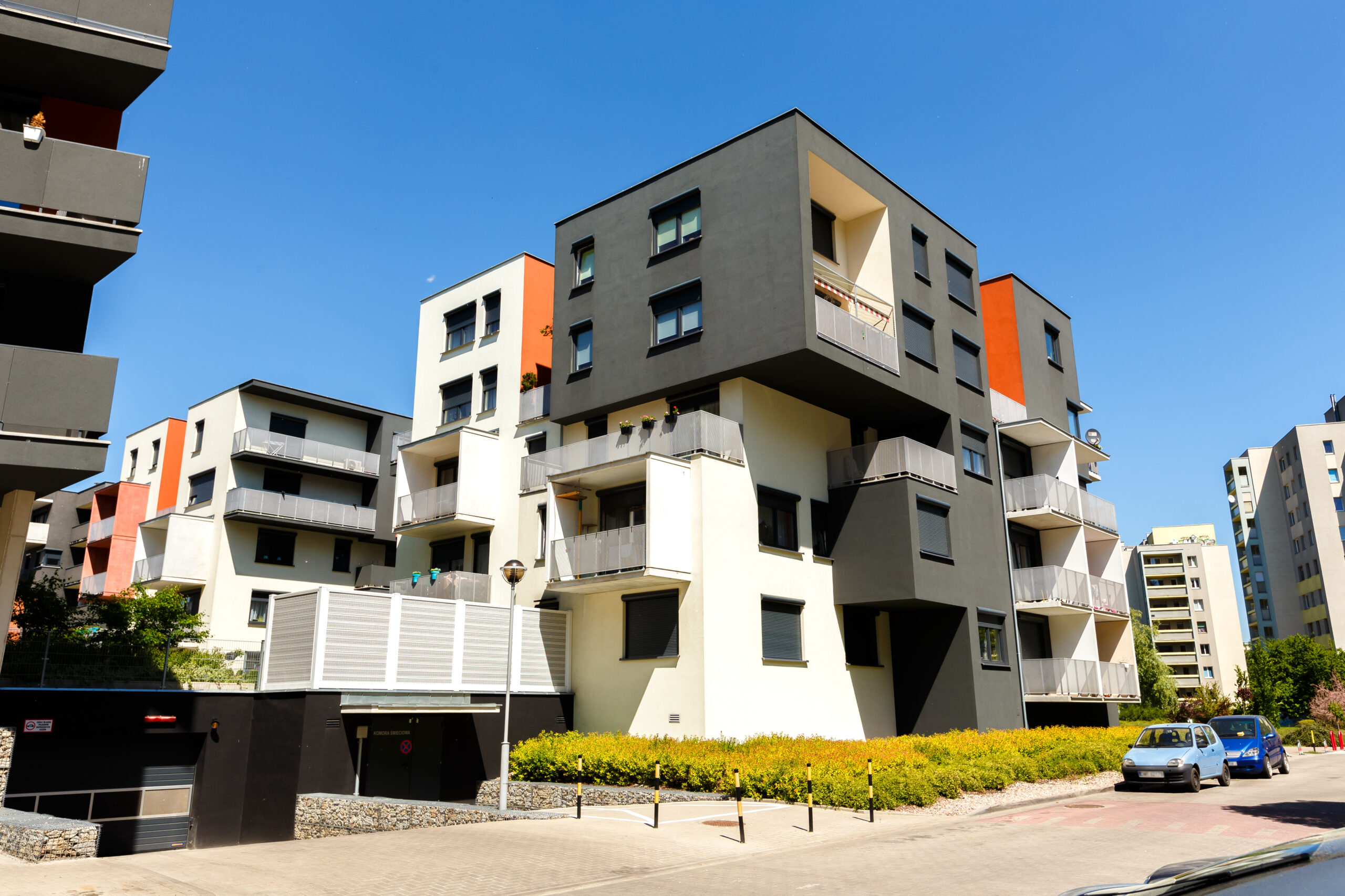 Exterior of a modern  apartment buildings on a blue sky background. No people.  Real estate business concept.